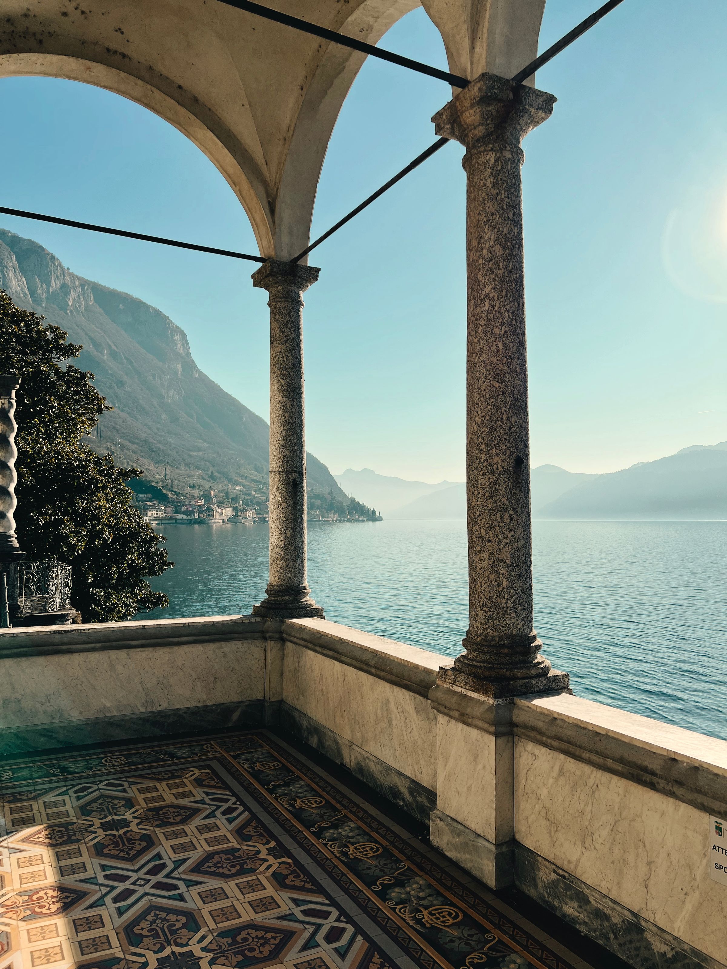 Stone arches framing Lake Como